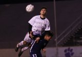 Lemoore's Adam Ramirez gets a header in match against Redwood High School.